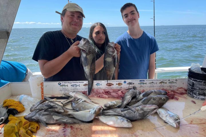 a person holding a fish on a boat in the water