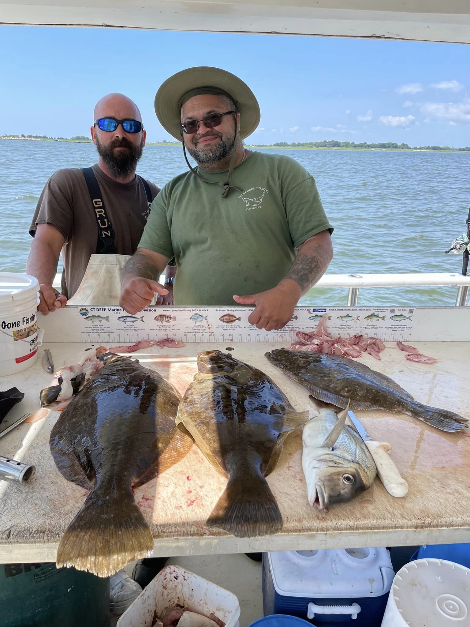 a person holding a fish on a boat in the water