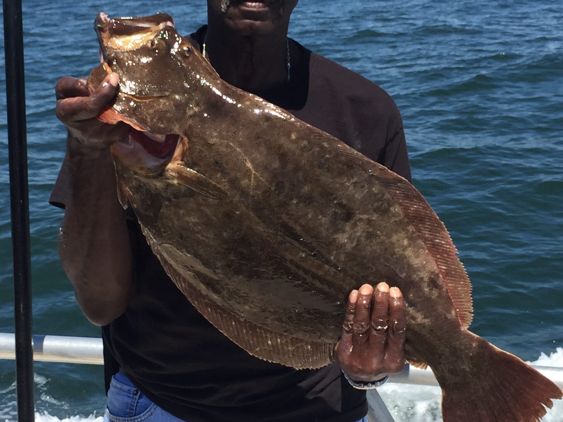 a man holding a fish in the water