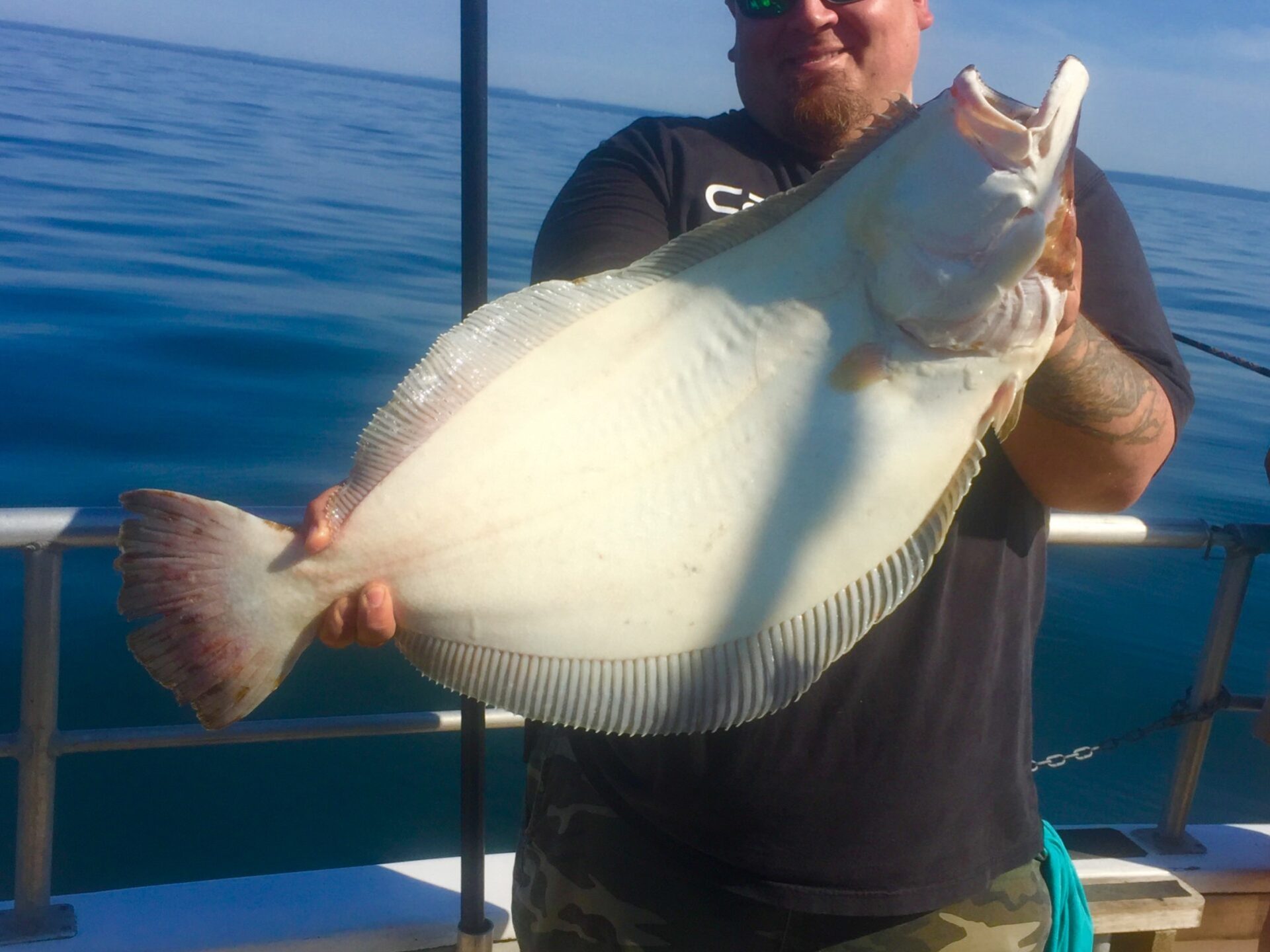 a man holding a fish in the water