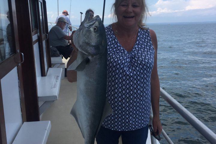 a person standing in front of a fish