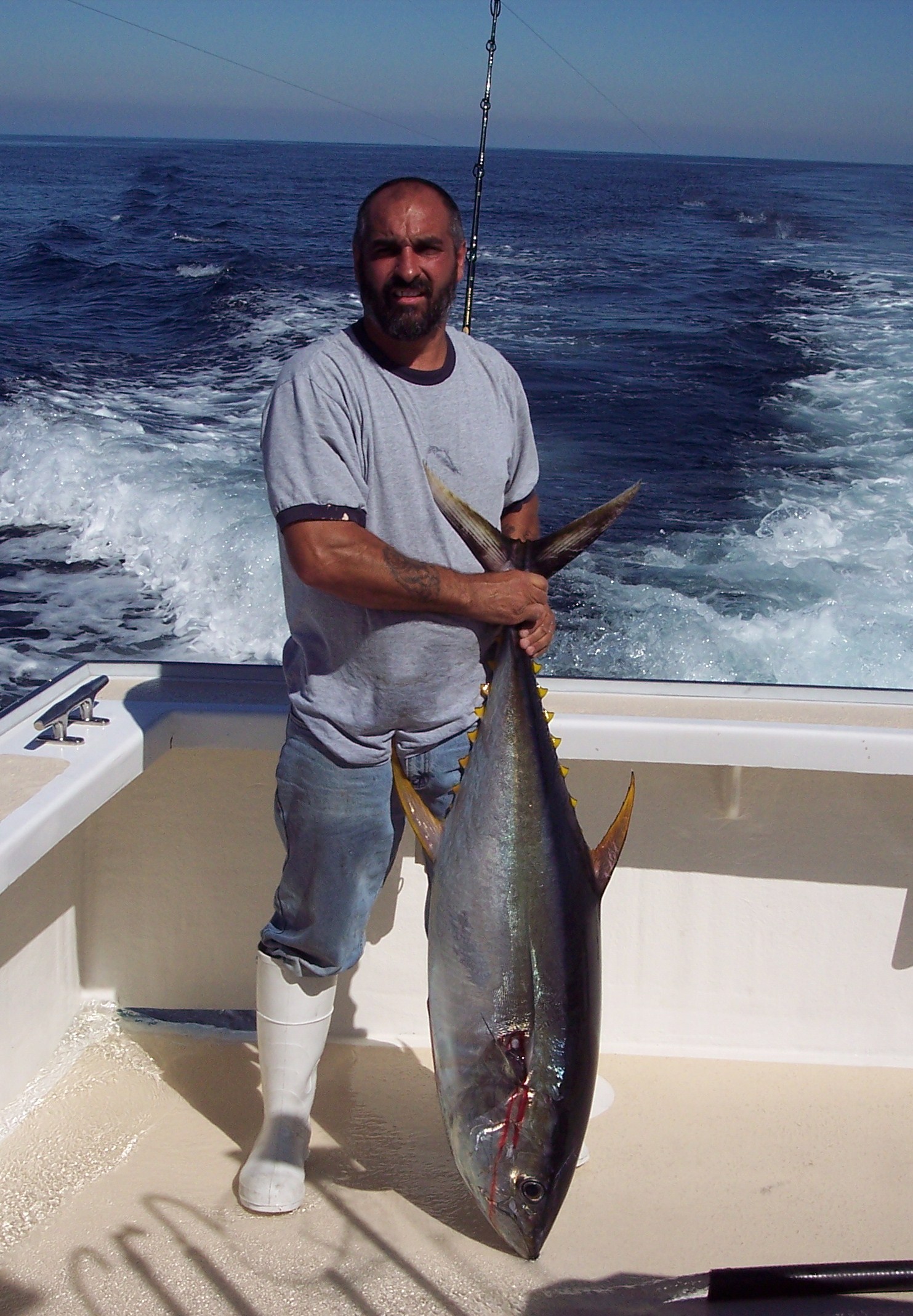 a man holding a fish in the water