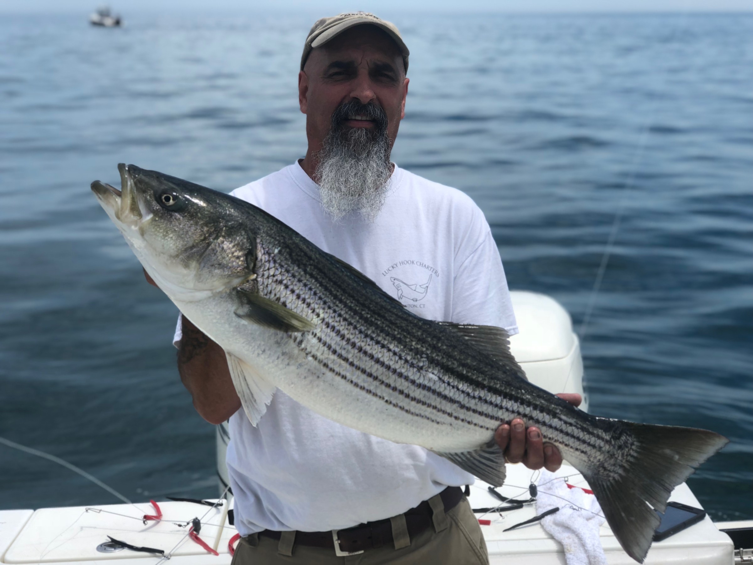a man holding a fish in the water