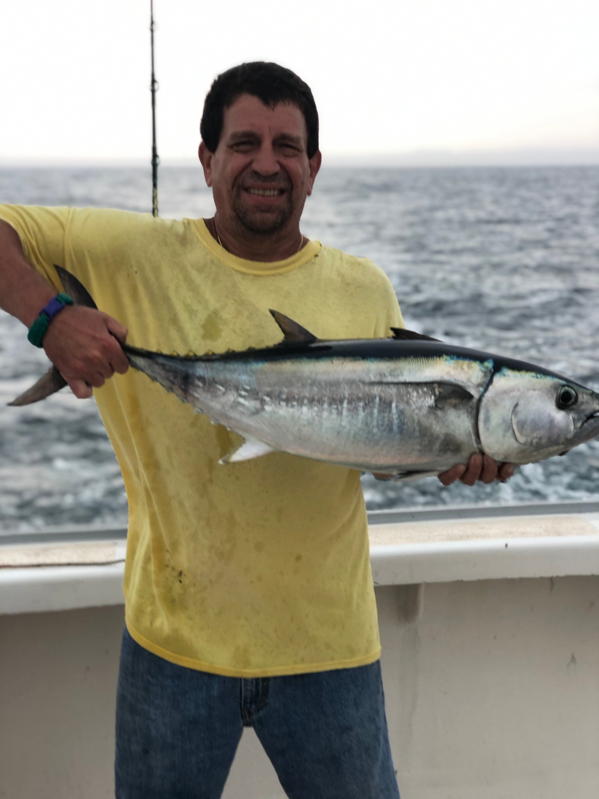 a man holding a fish in the water